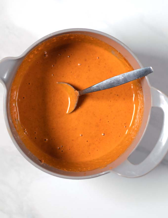 Ready peanut-lime dressing with a spoon.