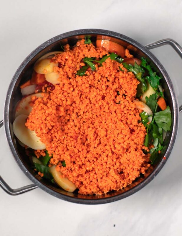 Red lentils are gven to the soup.