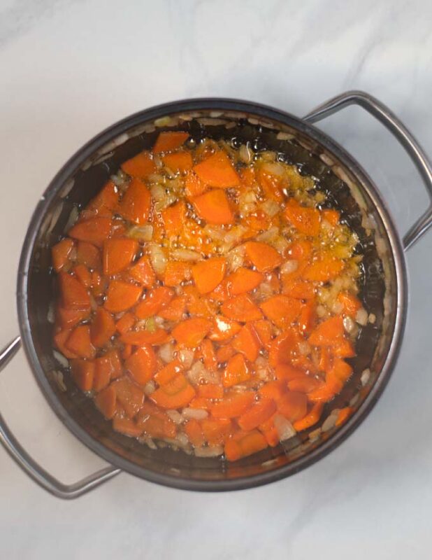Carrots and onions are sauteed in oil.