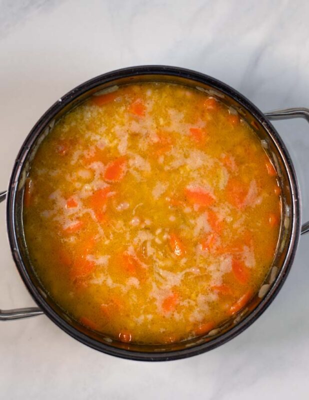 Vegetable broth and beans are added.